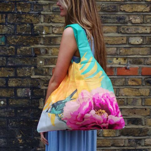 The Botanical Eco Bag by Loqi has a botanical print and a bird in lovely vibrant colours.